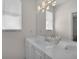 Clean bathroom with a marble counter and a large mirror and window at 3513 Dileuca St, Punta Gorda, FL 33950