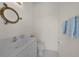 Charming powder room with a porthole-style mirror adding nautical flair at 3513 Dileuca St, Punta Gorda, FL 33950