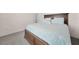 Bedroom with gray carpet and queen bed with blue leafy pattern comforter and matching pillows at 3513 Dileuca St, Punta Gorda, FL 33950