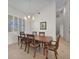 Formal dining room featuring a large wooden table, comfortable chairs, a decorative chandelier, and tile flooring at 3513 Dileuca St, Punta Gorda, FL 33950