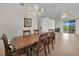 Formal dining room featuring a large wooden table, comfortable chairs, a decorative chandelier, and tile flooring at 3513 Dileuca St, Punta Gorda, FL 33950
