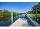 Water canal dock with concrete walkway on clear, sunny day with beautiful blue sky at 3513 Dileuca St, Punta Gorda, FL 33950