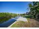 Dock on the canal featuring a boat lift, canal view, and lush foliage in the background at 3513 Dileuca St, Punta Gorda, FL 33950
