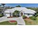 A charming home features a pristine white roof and lush landscaping, adding curb appeal to the property at 3513 Dileuca St, Punta Gorda, FL 33950