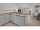 Open-concept kitchen with all white cabinets, appliances, and a cozy dining area at 3513 Dileuca St, Punta Gorda, FL 33950