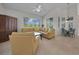 Bright, open living room featuring a corner sofa, view of lanai, and dining area with chandelier at 3513 Dileuca St, Punta Gorda, FL 33950