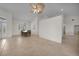 Bright, open living room with neutral tile flooring, a ceiling fan, and lots of natural light at 3513 Dileuca St, Punta Gorda, FL 33950