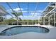 Screened pool area with a clear blue pool and views of tropical foliage and waterway at 3513 Dileuca St, Punta Gorda, FL 33950