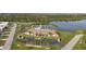Aerial view of community center showcasing a sparkling pool, tennis courts, and lush landscaping at 3520 Kenneth Rd, Port Charlotte, FL 33953