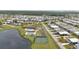 Aerial showcasing a lively community, clubhouse, pool, and sports courts, promoting an active lifestyle at 3520 Kenneth Rd, Port Charlotte, FL 33953