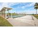 Community shuffleboard and bocce ball courts with covered seating overlooking a tranquil lake at 3520 Kenneth Rd, Port Charlotte, FL 33953