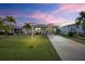 Charming single-story home with well-maintained lawn, palm trees, and a long driveway at 3520 Kenneth Rd, Port Charlotte, FL 33953