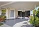 Charming front porch with space to sit and relax, a welcoming entrance to the home, and beautiful landscaping at 3520 Kenneth Rd, Port Charlotte, FL 33953