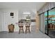 Bright kitchen with breakfast bar, white cabinets, and seamless access to sliding doors at 3520 Kenneth Rd, Port Charlotte, FL 33953