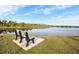 Scenic lake view with a comfortable bench, surrounded by lush greenery, perfect for relaxation at 3520 Kenneth Rd, Port Charlotte, FL 33953