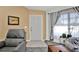 Comfortable living room seating with tile flooring, accent wall, large window, and cozy seating at 3520 Kenneth Rd, Port Charlotte, FL 33953