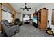 Cozy living room features comfortable seating, a ceiling fan, and entertainment center at 3520 Kenneth Rd, Port Charlotte, FL 33953