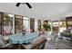 Bright sunroom with lots of windows, dining table, rattan chairs, and comfortable couch at 3520 Kenneth Rd, Port Charlotte, FL 33953
