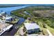 Stunning aerial view of waterfront home, lush landscaping, private dock, and picturesque river access at 3712 Balboa Ct, Punta Gorda, FL 33983