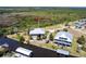 An aerial view of home and surrounding homes along a wide canal, with boat docks at 3712 Balboa Ct, Punta Gorda, FL 33983