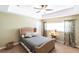 Bright bedroom featuring a tray ceiling, ceiling fan, and a wicker bed frame at 3712 Balboa Ct, Punta Gorda, FL 33983
