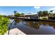 Covered boat dock with a boat lift on a sunny day at 3712 Balboa Ct, Punta Gorda, FL 33983