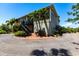 Exterior showcasing the home's architecture, a gravel driveway, a brick walkway, and lush landscaping at 3712 Balboa Ct, Punta Gorda, FL 33983