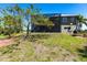 Backyard view of the home highlighting the screened-in lanai and well-manicured lawn at 3712 Balboa Ct, Punta Gorda, FL 33983