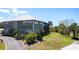 Well-maintained home featuring a metal roof, lush landscaping, and a screened-in lanai at 3712 Balboa Ct, Punta Gorda, FL 33983