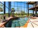 Indoor pool and spa area with large windows, offering a seamless indoor-outdoor living experience at 3712 Balboa Ct, Punta Gorda, FL 33983