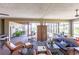 Bright sunroom with brick flooring, wicker furniture, and floor-to-ceiling windows offering panoramic outdoor views at 3712 Balboa Ct, Punta Gorda, FL 33983