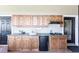 Outdoor wet bar equipped with wooden cabinetry, sink, mini-fridge, and cooktop for convenient entertaining at 3712 Balboa Ct, Punta Gorda, FL 33983