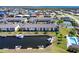 Aerial view of condo community with marina, nearby tennis court, and waterfront access at 4000 Bal Harbor Blvd # 124, Punta Gorda, FL 33950