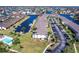 Aerial view shows condo community with canals, boat docks, parking, pool and tennis court at 4000 Bal Harbor Blvd # 124, Punta Gorda, FL 33950