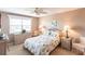 Serene bedroom with a ceiling fan, wicker furnishings and natural light from the window at 4000 Bal Harbor Blvd # 124, Punta Gorda, FL 33950