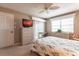 Comfortable bedroom with wicker furniture, natural light and sliding glass doors to a balcony at 4000 Bal Harbor Blvd # 124, Punta Gorda, FL 33950