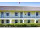 Exterior of condo building showcasing architecture with balconies and manicured landscaping at 4000 Bal Harbor Blvd # 124, Punta Gorda, FL 33950