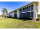 This shows the exterior of the condo building with enclosed patios and lush landscaping at 4000 Bal Harbor Blvd # 124, Punta Gorda, FL 33950