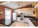 Bright kitchen with white cabinetry, marble countertops and modern appliances at 4000 Bal Harbor Blvd # 124, Punta Gorda, FL 33950