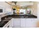Well-equipped kitchen with granite countertops, white appliances and a breakfast bar overlooking the living area at 4000 Bal Harbor Blvd # 124, Punta Gorda, FL 33950