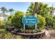 Community sign for Spinnaker Point with a sailboat logo and tropical landscaping at 4000 Bal Harbor Blvd # 124, Punta Gorda, FL 33950