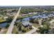 An aerial view highlighting the home's waterfront location, canal access, and proximity to local roads at 4010 Yucatan Cir, Port Charlotte, FL 33948