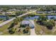 An aerial view of a home showcasing waterfront canal access and neighborhood surroundings at 4010 Yucatan Cir, Port Charlotte, FL 33948
