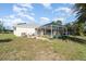This backyard includes a pool, a screened-in lanai, and tropical landscaping at 4010 Yucatan Cir, Port Charlotte, FL 33948