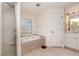 Bright bathroom featuring a soaking tub and glass enclosed shower at 4010 Yucatan Cir, Port Charlotte, FL 33948