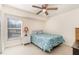 Bright bedroom features a ceiling fan, a window and comfortable carpet at 4010 Yucatan Cir, Port Charlotte, FL 33948