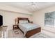Cozy bedroom with carpet, ceiling fan, natural light from a window, and a queen bed at 4010 Yucatan Cir, Port Charlotte, FL 33948