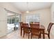 Bright dining area with wooden table, chairs, and sliding door access to pool and lanai at 4010 Yucatan Cir, Port Charlotte, FL 33948