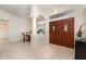 Inviting foyer with tile flooring, a dining area, and an ornate double-door entrance at 4010 Yucatan Cir, Port Charlotte, FL 33948