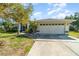 A well-maintained home with a large garage, screened entry, and landscaped front yard at 4010 Yucatan Cir, Port Charlotte, FL 33948